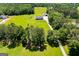 Expansive property with a charming home, lush green lawn, mature trees, and a detached garage at 640 Lovell Rd, Temple, GA 30179