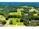 Beautiful aerial view of sprawling estate with multiple homes, surrounded by lush greenery and trees at 640 Lovell Rd, Temple, GA 30179