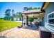 Expansive backyard with a covered patio, brick flooring, grill, and detached garage with ample space at 640 Lovell Rd, Temple, GA 30179