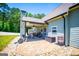 Well-maintained backyard features a covered patio, brick flooring, landscaping, and storage at 640 Lovell Rd, Temple, GA 30179