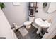 Powder room with stylish pedestal sink, modern fixtures, and dark wood-look tile flooring at 640 Lovell Rd, Temple, GA 30179