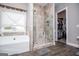 Spa-like bathroom features a large soaking tub and tiled shower with glass door at 640 Lovell Rd, Temple, GA 30179