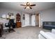 Spacious room featuring gray walls, a ceiling fan, a barn door, a crib, and desk area at 640 Lovell Rd, Temple, GA 30179
