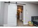 Large bedroom featuring a barn door, crib and sitting area that offers serene space at 640 Lovell Rd, Temple, GA 30179