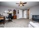 Spacious room featuring gray walls, a ceiling fan, a barn door, a crib, and desk area at 640 Lovell Rd, Temple, GA 30179