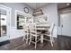Dining area with modern light fixture, wood floors, a dining table with six chairs, and natural light at 640 Lovell Rd, Temple, GA 30179