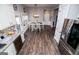 Open dining area with hardwood floors, white table and chairs, and stainless steel refrigerator at 640 Lovell Rd, Temple, GA 30179