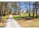 Scenic gravel driveway leading to a home surrounded by trees and lush greenery at 640 Lovell Rd, Temple, GA 30179