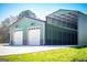 This building has dual garages with green siding and metal overhang at 640 Lovell Rd, Temple, GA 30179