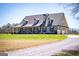 Inviting home featuring a covered porch, well-manicured lawn, and attached garages at 640 Lovell Rd, Temple, GA 30179