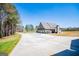 A long driveway leading up to this large house with side facing garages at 640 Lovell Rd, Temple, GA 30179