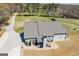 An aerial view of a home with a beautiful patio and a long driveway on a sunny day at 640 Lovell Rd, Temple, GA 30179