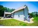 Side view of the home with a covered patio, stone columns, landscaping, and well-manicured lawn at 640 Lovell Rd, Temple, GA 30179