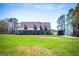 Charming home featuring a large front yard, covered porch, and a detached garage at 640 Lovell Rd, Temple, GA 30179