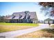 Lovely home with a charming covered porch, a long driveway, and a detached garage at 640 Lovell Rd, Temple, GA 30179