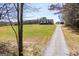 A beautiful home nestled on a large lot, showcasing a long driveway and detached garage at 640 Lovell Rd, Temple, GA 30179
