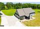 Aerial view of the rear of a home featuring a large yard and multiple garages and outdoor spaces at 640 Lovell Rd, Temple, GA 30179