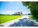 Sprawling property featuring a large lawn, long driveway, and a detached garage at 640 Lovell Rd, Temple, GA 30179