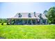 Charming single-story home featuring a welcoming front porch, dormer windows, and a well-manicured front yard at 640 Lovell Rd, Temple, GA 30179