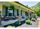 Inviting front porch with stone pillars, black shutters, and decorative plants at 640 Lovell Rd, Temple, GA 30179