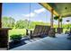 Relaxing front porch featuring a wooden swing, offering a tranquil spot to unwind and enjoy the outdoors at 640 Lovell Rd, Temple, GA 30179