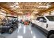 Garage with multiple vehicles, exposed beam ceiling, and an American flag on the back wall at 640 Lovell Rd, Temple, GA 30179