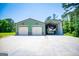 Exterior view of a large, two-car garage with an adjoining tall carport for RV parking and a concrete driveway at 640 Lovell Rd, Temple, GA 30179