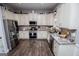 Kitchen with granite countertops, stainless steel appliances, white cabinets, and hardwood floors at 640 Lovell Rd, Temple, GA 30179