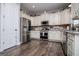 Kitchen featuring white cabinets, stainless steel appliances, granite countertops, and hardwood floors at 640 Lovell Rd, Temple, GA 30179
