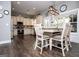 A cozy kitchen with white cabinets, wooden floors, modern lighting, and a dining table at 640 Lovell Rd, Temple, GA 30179