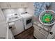 Well-equipped laundry room with modern washer and dryer, granite countertop, and wooden-look floors at 640 Lovell Rd, Temple, GA 30179