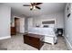 Spacious main bedroom with modern ceiling fan, gray walls, neutral carpet, and stylish furniture at 640 Lovell Rd, Temple, GA 30179