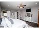 Spacious main bedroom with dark wood floors, stylish furniture, sliding barn doors, and a view to the en suite at 640 Lovell Rd, Temple, GA 30179