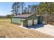 An exterior angle shot of a green outbuilding with two garage doors and a metal roof at 640 Lovell Rd, Temple, GA 30179