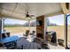 Covered patio area with a fireplace, ceiling fan, and outdoor furniture perfect for entertaining with a large field view at 640 Lovell Rd, Temple, GA 30179