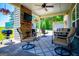 Cozy covered outdoor living space with a stone fireplace, grill, and comfortable seating for entertaining at 640 Lovell Rd, Temple, GA 30179