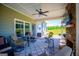 Covered patio with outdoor furniture, a ceiling fan, a stone fireplace, and views of the landscaped backyard at 640 Lovell Rd, Temple, GA 30179