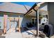 Covered patio featuring an outdoor shower, seating area, and access to the home's backyard at 640 Lovell Rd, Temple, GA 30179