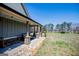 Charming porch with stone-base columns, a comfortable seating area, and views of the expansive front yard at 640 Lovell Rd, Temple, GA 30179