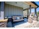 Cozy covered porch featuring a comfortable outdoor sofa and stylish rug at 640 Lovell Rd, Temple, GA 30179