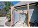 Outdoor shower featuring wood construction, a metal privacy screen, and decorative landscaping at 640 Lovell Rd, Temple, GA 30179