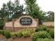 Community entrance sign made of brick and stone, surrounded by lush greenery and bushes at 227 Fenwick Cir, Mcdonough, GA 30253
