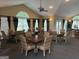 Community event space with tables, chairs, ceiling fan, and lighting at 227 Fenwick Cir, Mcdonough, GA 30253