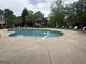 Community pool with ample seating, landscaping, and a nearby gazebo for relaxing at 227 Fenwick Cir, Mcdonough, GA 30253