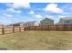Expansive backyard with wooden fence, manicured lawn and clear skies at 813 Royal Red Ct, Mcdonough, GA 30253