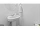 Bathroom featuring pedestal sink, round mirror, and neutral paint at 813 Royal Red Ct, Mcdonough, GA 30253
