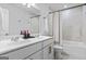 Bathroom featuring double sinks, shower with patterned curtain, and white tiling at 813 Royal Red Ct, Mcdonough, GA 30253