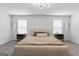 Bedroom with a beige bed, neutral carpet, and modern lighting at 813 Royal Red Ct, Mcdonough, GA 30253