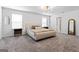 Bedroom with a large bed, neutral carpet, and natural light coming from two windows at 813 Royal Red Ct, Mcdonough, GA 30253