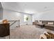 Open bonus room with a gray sofa, modern lighting, and neutral carpet at 813 Royal Red Ct, Mcdonough, GA 30253